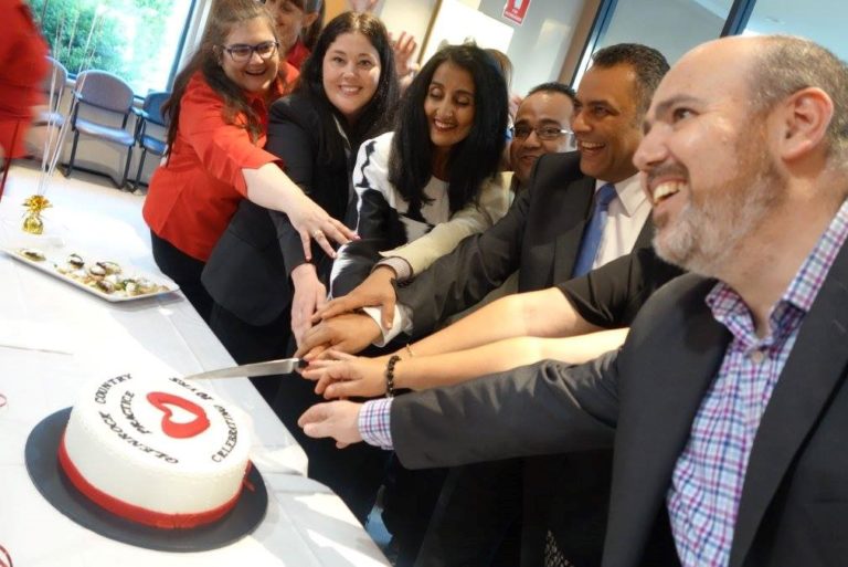 Image of Glenrock Country Practice staff cutting a cake celebrating 10 years