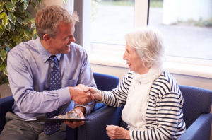 Image of doctor and elderley patient at their general practice, which is a health care home