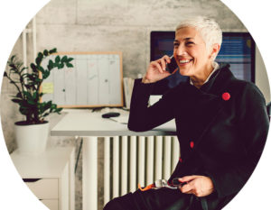 Header image of woman at desk on phone