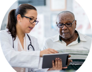 Image of a female doctor and older male patient looking at information on a tablet