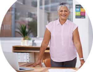 Image of practice manager smiling from behind her desk