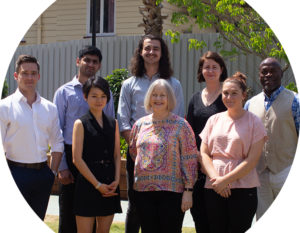 Image of a team of diverse AGPAL support staff in the sunshine smiling at the camera