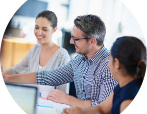 Image of a middle aged mad and two women working