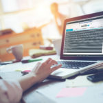 Woman manager working with project on laptop General day in office. Laptop and paperwork. Woman manager working with project on laptop