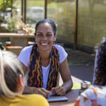 Close-up of young aboriginal students studying together outdoors in the sun in Australia.