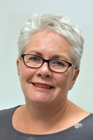 A profile headshot of AGPAL Board Director, Dr Sue Harrisons smiling